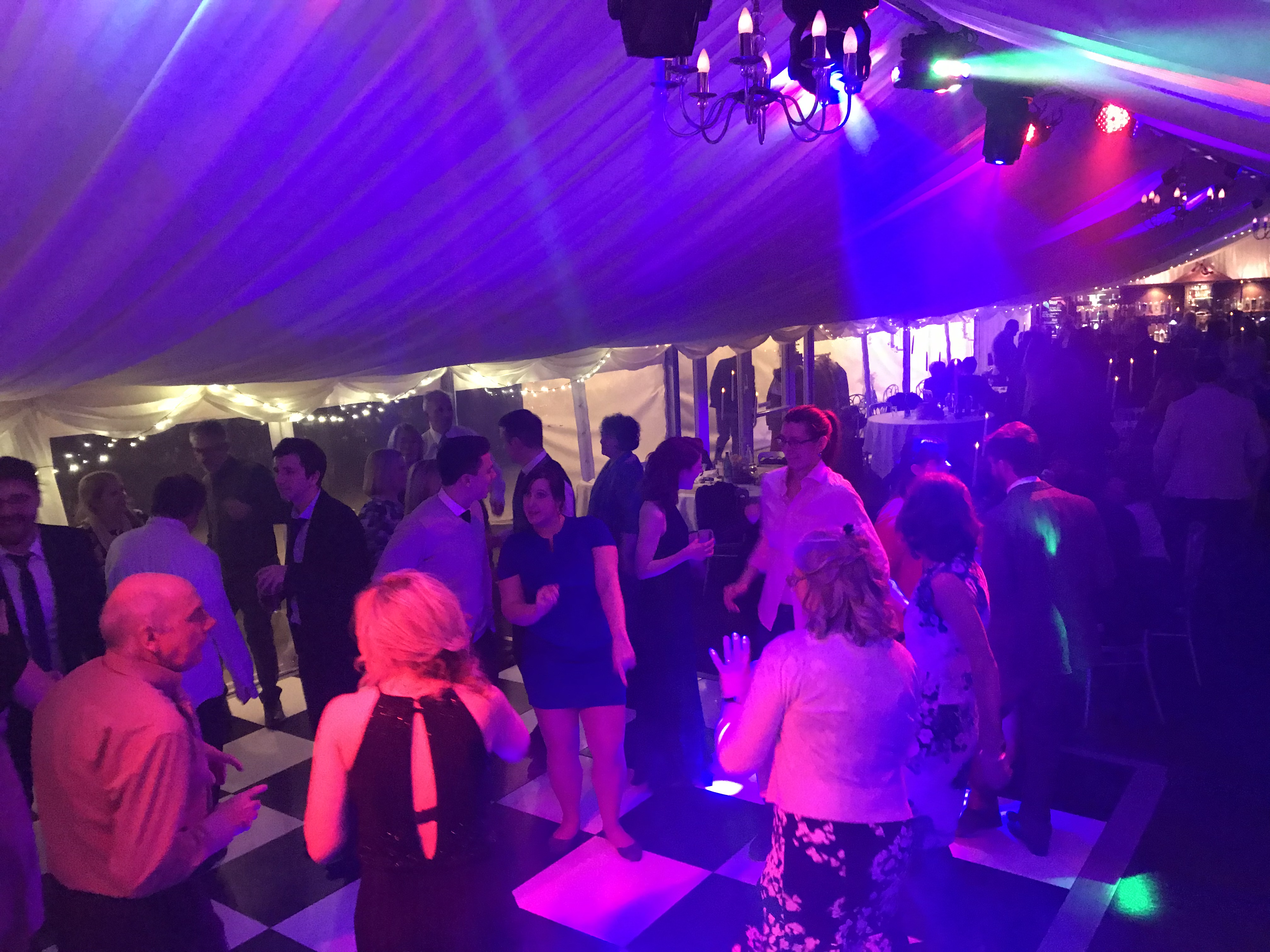 Crowded dance floor with purple lighting