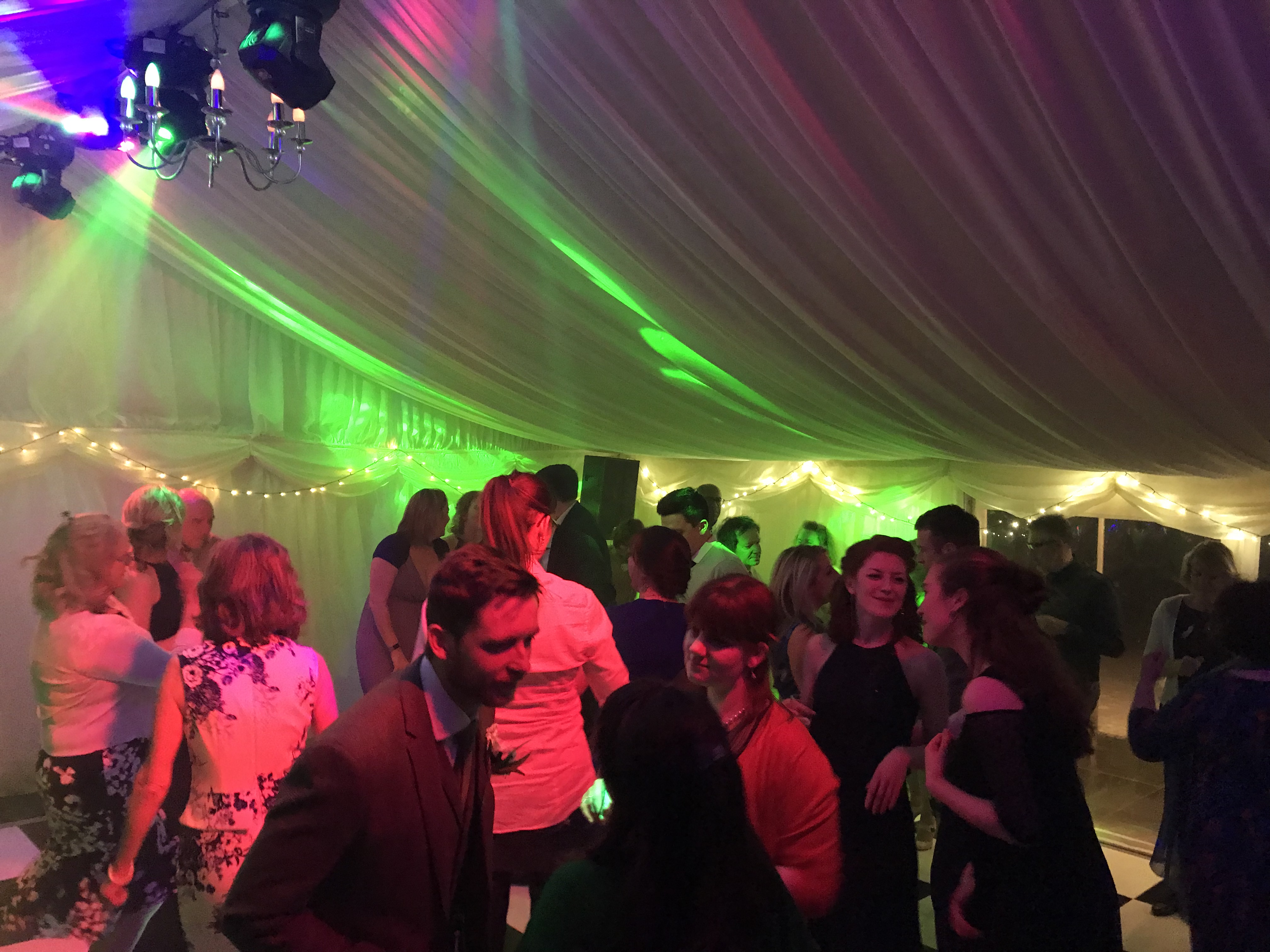 Marquee dance floor with green uplighting
